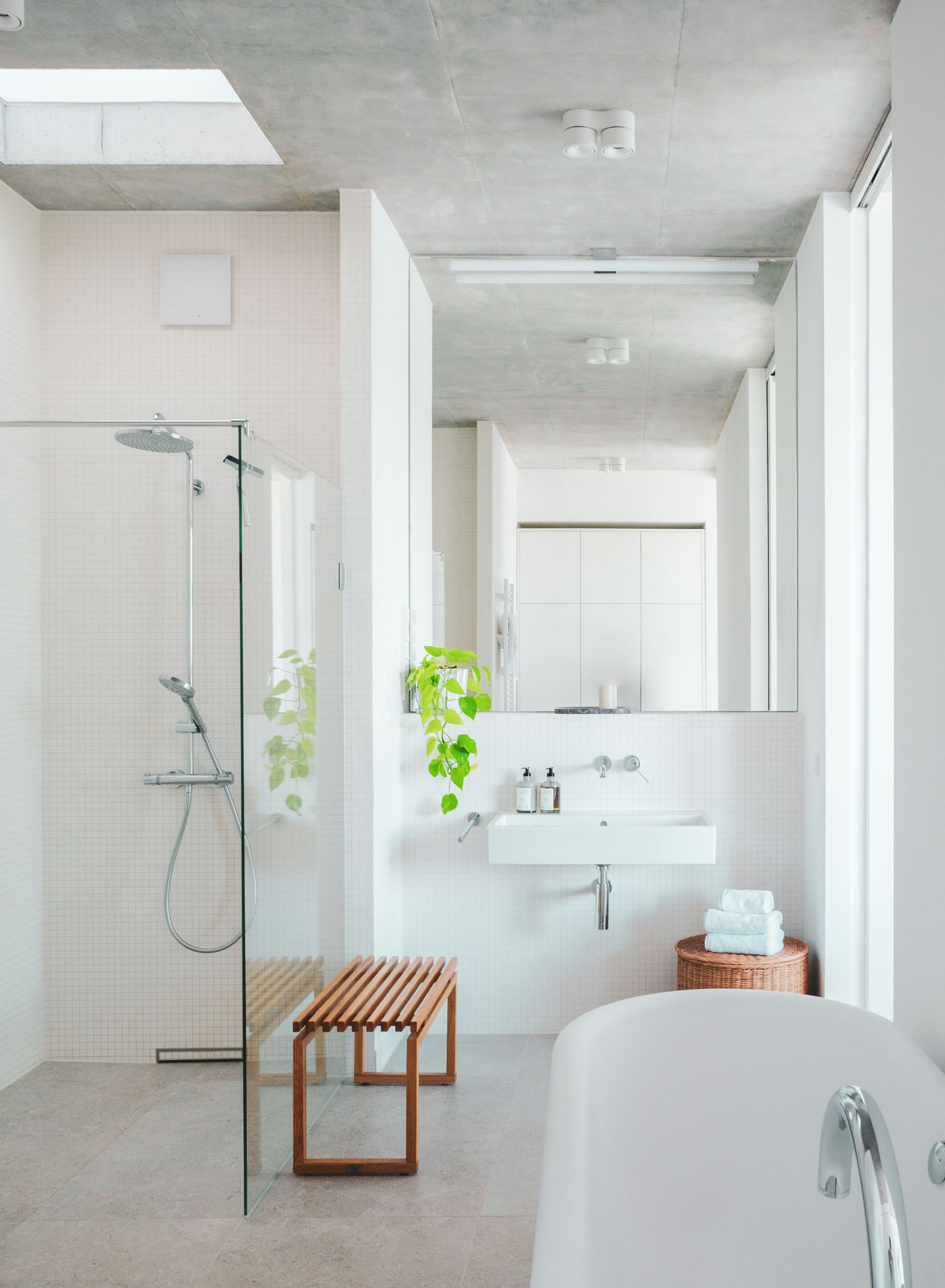 A bathroom with a tub, sink, and shower